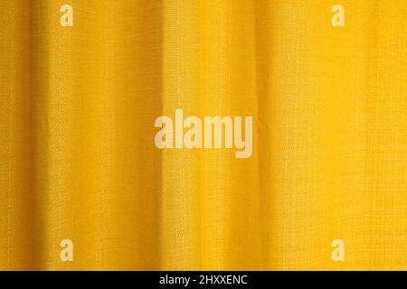 Fabric yellow curtains with folds . Abstract background, curtain, drapes gold fabric. Stock Photo