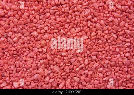 Texture of red decorative small stones. Abstract background. Stock Photo