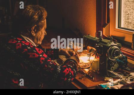 Tailor couturier measuring cloth. Closeup of sewer woman hands