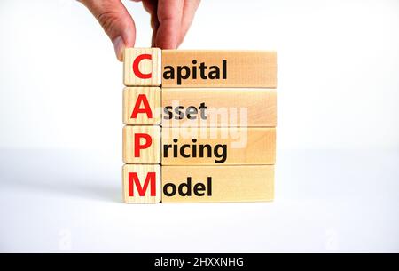 CAPM capital asset pricing model symbol. Concept words CAPM capital asset pricing model on blocks on a beautiful white background. Business CAPM capit Stock Photo