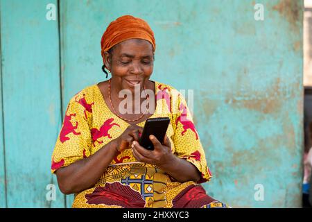 Beautiful elderly African woman using her smartphone Stock Photo