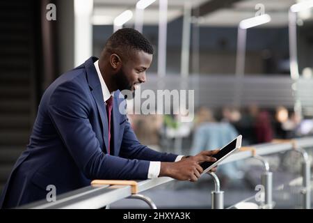 Smiling african american businessman using digital tablet Stock Photo