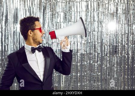 Black man in disco club scream in megaphone Stock Photo