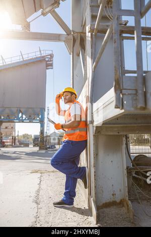 Young engineer working hard on concrete plant Stock Photo