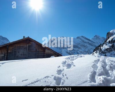 Mürren, Switzerland - March 1st 2022: A typical Swiss mountain hut on a sunny winter day Stock Photo