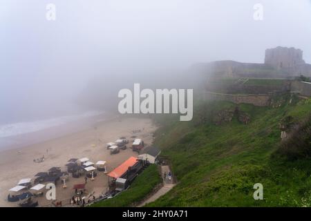 View of the Long Sands Beach and the Tynemouth Priory and Castle in North East England on a misty day Stock Photo