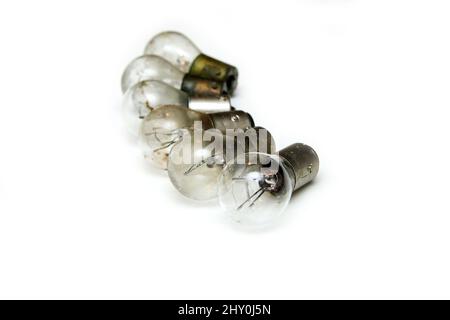 The small group of old shabby small bulbs for the car lights isolated in the white background. Stock Photo