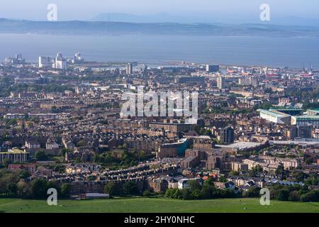 City view of East Edinburgh and the ocean in the distance taken from Arthur's Seat in Holyrood Park Stock Photo