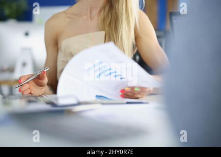 Office lady go through papers at work, business meeting, checking financial report Stock Photo