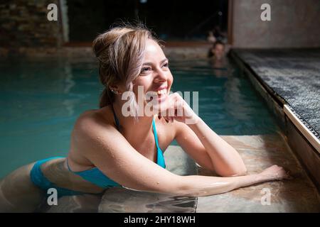 Side view of female doctor in medical uniform and sterile mask text messaging on cellphone in clinic Stock Photo