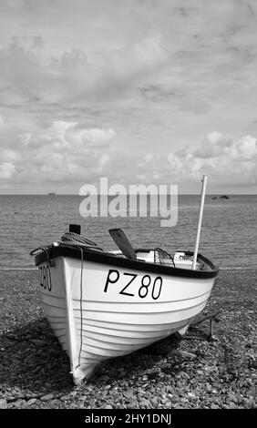 small boat on a shingle  beach in black and white no people nobody Stock Photo