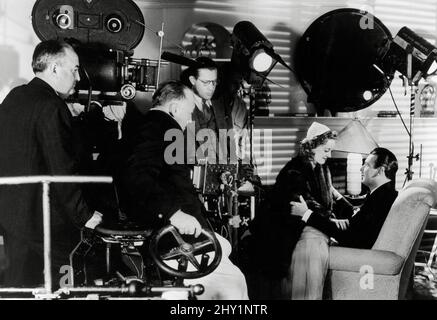 Director Edmund Goulding, Bette Davis, George Brent, during the making of,  'Dark Victory' (1939) Warner Bros.File Reference # 34145-683THA Stock Photo