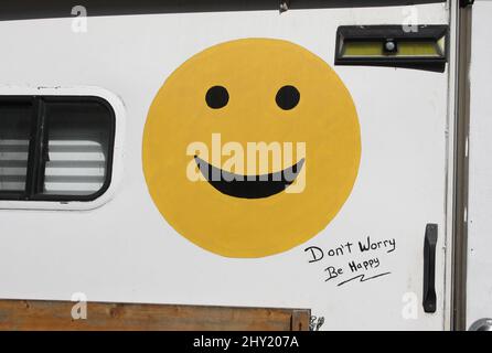 Smiley emoji face and Don't worry, Be Happy text on the old trailer  in Vancouver, Canada Stock Photo