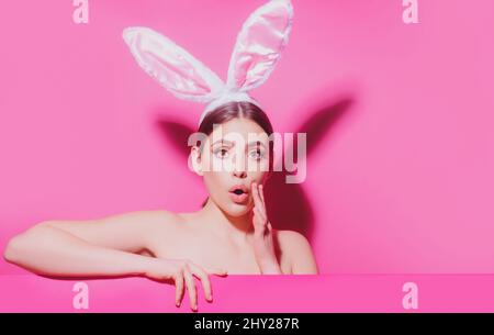 Young woman with bunny ears. Thinking surprised. Funny emotions, excited expressing. Stock Photo
