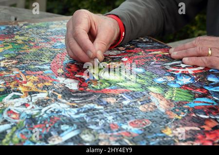 Man Doing a Marvel 1000 Piece Impossible Puzzle Stock Photo
