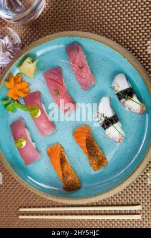 Assorted premium tuna and salmon nigiri sushi on a beautifully decorated plate. Stock Photo