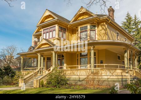 Barclay Manor Home of West End Seniors Network on 1447 Barclay Street in Vancouver. Beautiful old yellow house on the street of Vancouver Canada-March Stock Photo