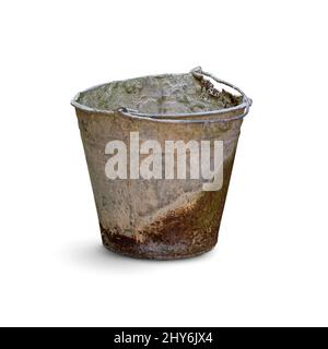 Old dirty rusty bucket with the remains of dried cement isolated on white background. Stock Photo