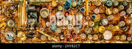 Top view of different paint cans on a wooden board Stock Photo