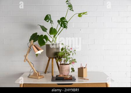 Desk top office space with lamp and laptop. Stock Photo