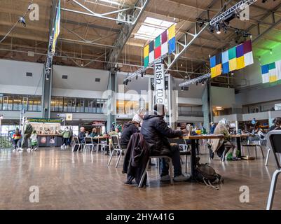 Seattle, WA USA - circa March 2022: People enjoying the Seattle Irish Week Festival inside the Armory Food and Event Hall. Stock Photo