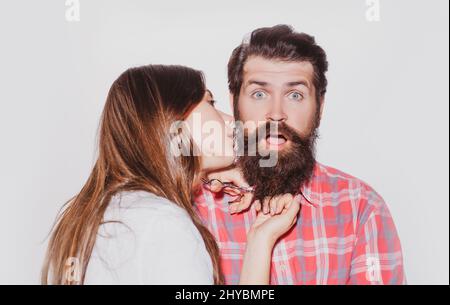 Funny couple shaving. Barbershop beard care. Bearded man getting haircut by hairdresser. Barber scissors and straight razor. Stock Photo