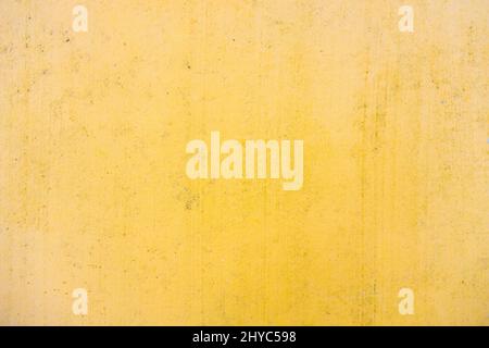 Old yellow concrete wall with scratches Stock Photo