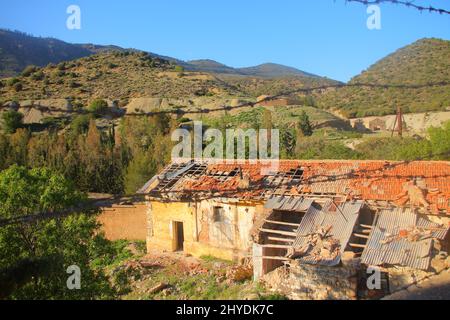 High angle shot of an abandoned broken building below the mountains Stock Photo