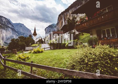 Great view of alpine village. Gorgeous scene. Location place Swiss alp, Lauterbrunnen valley, Staubbach waterfall, Europe. Cross process, retro and vi Stock Photo
