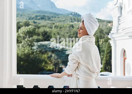 woman posing against the backdrop of mountains on the balcony architecture Perfect sunny morning Stock Photo