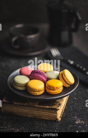 Sweet colorful macarons. Traditional french macaroons. Tasty dessert on the plate. Stock Photo