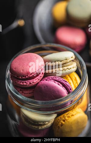 Sweet colorful macarons. Traditional french macaroons. Tasty dessert in the jar. Stock Photo