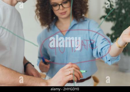 Startup. Curly woman and man drawing mind map, making business. Office Stock Photo