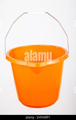 Orange plastic bucket on white background Stock Photo