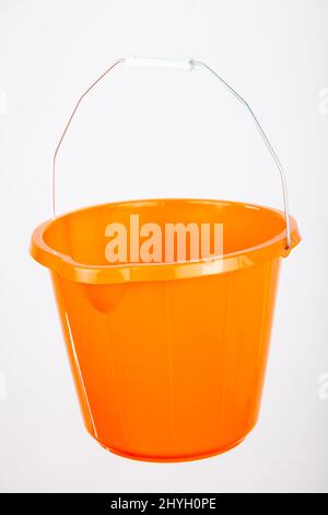 Orange plastic bucket on white background Stock Photo