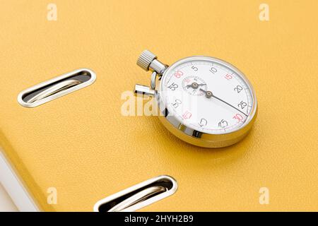 Yellow office folder on the chronometer. Stock Photo