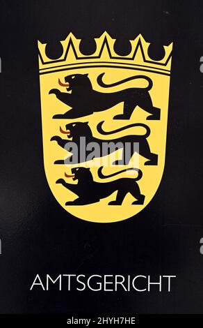 Karlsruhe, Germany. 15th Mar, 2022. In front of the Karlsruhe District Court, the lettering Amtsgericht and the coat of arms of Baden-Württemberg are displayed on a mailbox. A trial for tax evasion amounting to millions of euros was opened in the court. The defendant, a former managing director of a now insolvent kebab skewer manufacturer, is alleged to have evaded taxes in eight cases from 2017 to 2019 with a total loss amounting to millions. Credit: Uli Deck/dpa/Alamy Live News Stock Photo