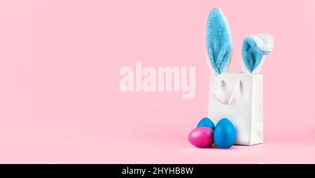 Wide banner on a pink background. The concept of online shopping for Easter Stock Photo