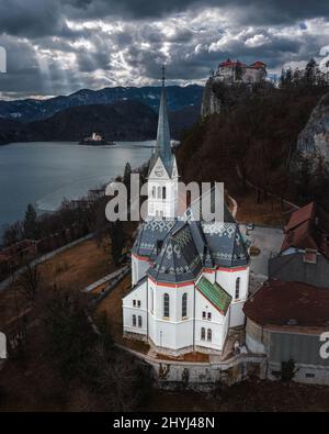 Bled, Slovenia - Aerial panoramic view of St. Martin's Parish Church with Bled Castle (Blejski Grad), Bled Island and Julian Alps at the background on Stock Photo