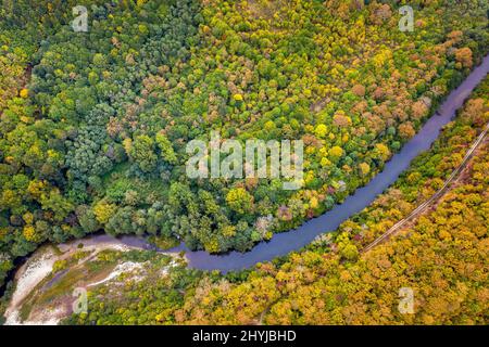Aerial view from drone of the river across mountain hills with autumn trees Stock Photo