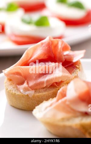 Italian appetizer bruschetta with Parma ham on a plate Stock Photo