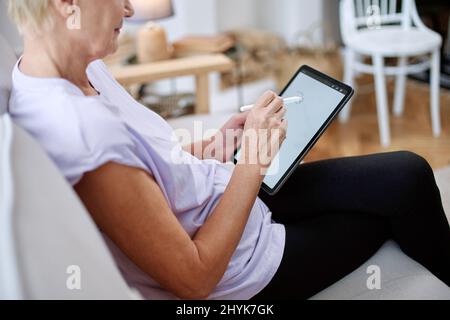 elderly woman designer working on a graphics tablet. close-up. Stock Photo