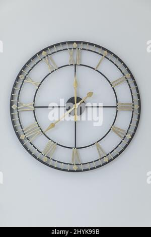 A closeup shot of modern transparent designed clock on a white wall Stock Photo