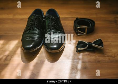 Groom's wedding accessories: shoes, belt and bow tie Stock Photo