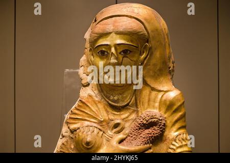 Torino, Italy - August 14, 2021: Gilded covering for a female mummy at the Egyptian Museum of Turin, Italy. Stock Photo