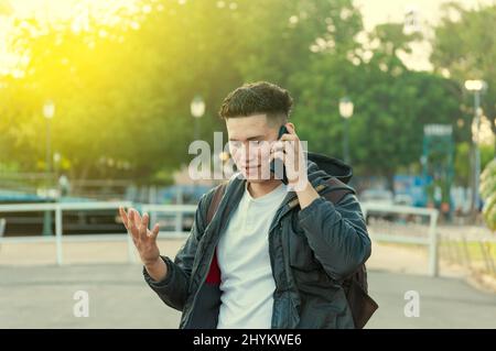 Man calling on the phone, young man calling on cell phone, latin guy calling on the phone Stock Photo