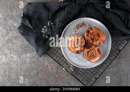 Delicious and healthy dessert of baked quince with nuts. Stock Photo