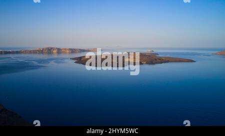 Drone shot, morning atmosphere, caldera, view of volcanic islands Nea Kameni, Palea Kameni and Aspronisi, view of southern tip of the island, sea Stock Photo