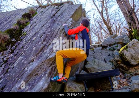 Climber bouldering in Chironico, Canton Ticino, Switzerland Stock Photo