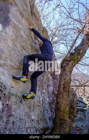 Climber bouldering in Chironico, Canton Ticino, Switzerland Stock Photo